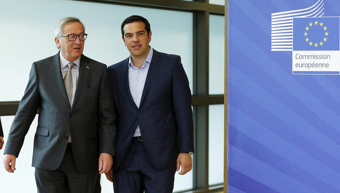 Greece's Prime Minister Alexis Tsipras (right) walking with European Commission President Jean-Claude Juncker (left) ahead of a meeting at the EU Commission headquarters in Brussels, Belgium, on June 3, 2015. -- PHOTO: REUTERS