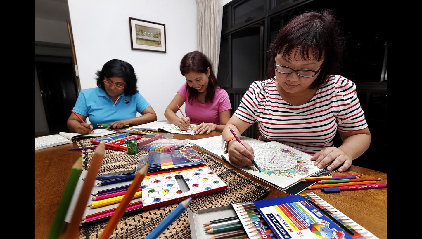 Calligraphy students (above) learn the basics, including how to use a pen to form letters. Friends and colouring hobbyists (from left) Jennifer Vas, Ana Jean Gonot and Olivia Ho, all aged 39.