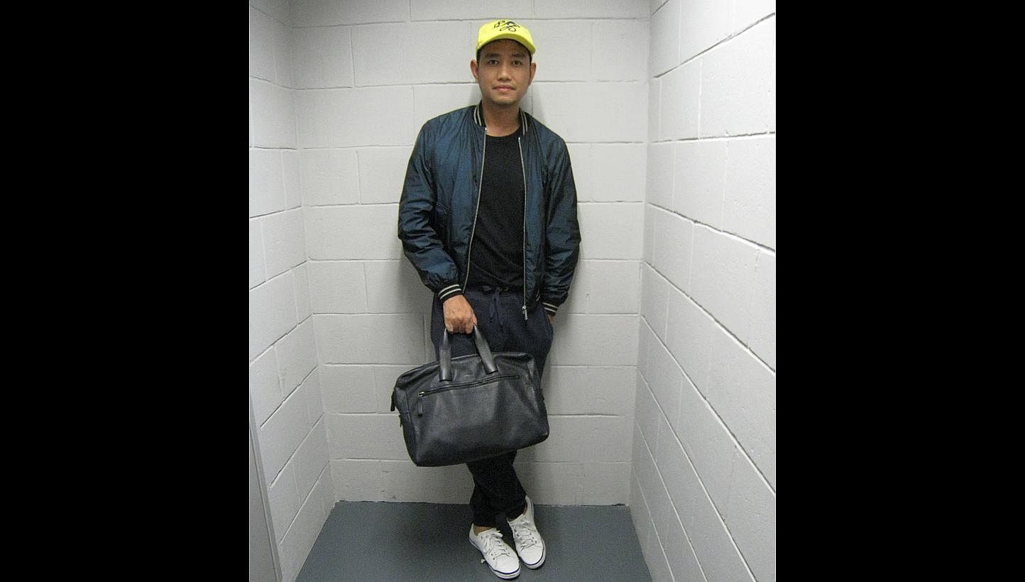 HIS BAG: Lanvin bag. It can pass as a business bag, and it is also soft and good for use on a casual day. The design is clean and simple, which is what I like in leather products. -- ST PHOTOS: SAMANTHA GOH