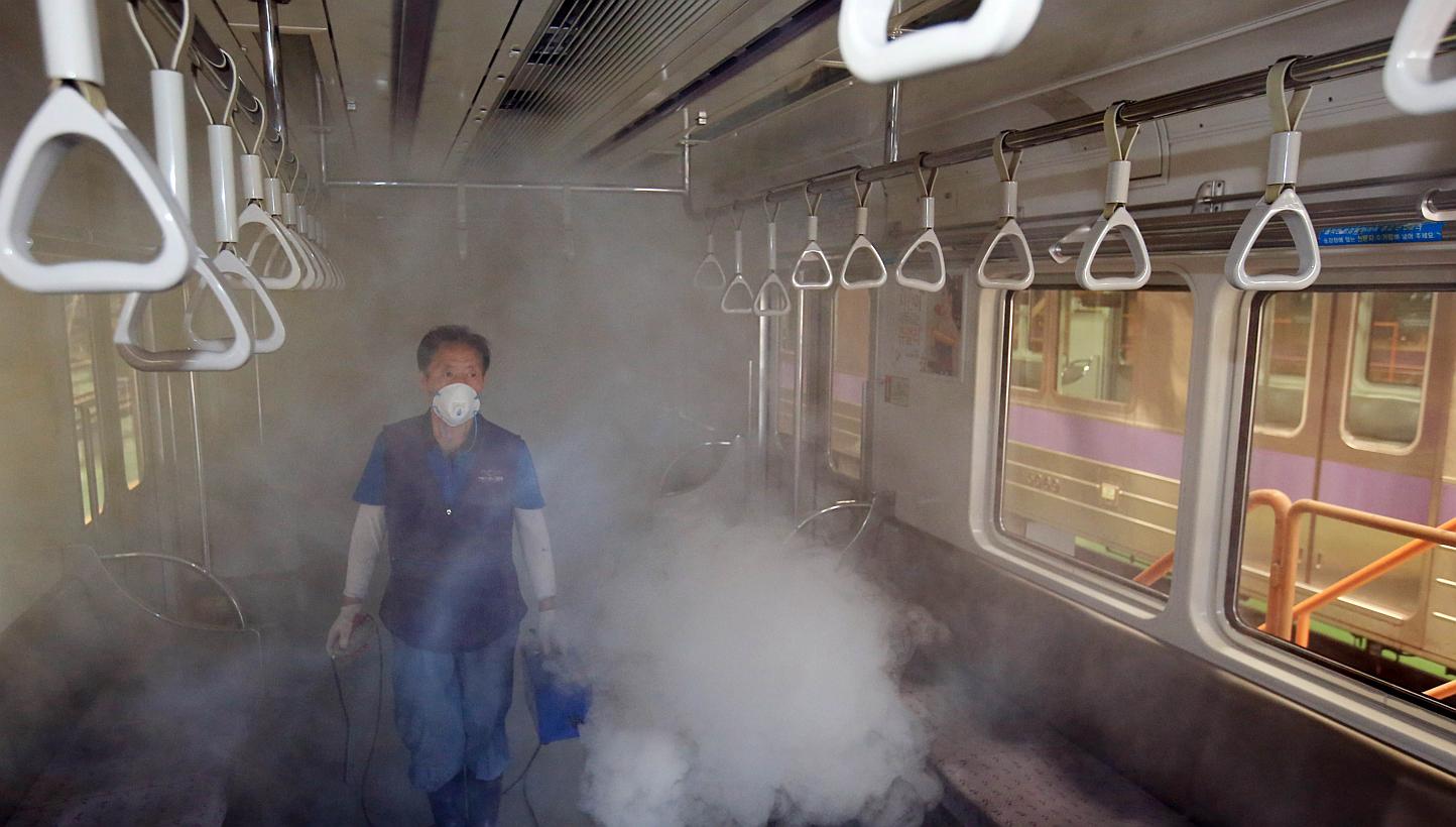 A subway train carriage in Seoul being disinfected on Thursday. The outbreak of Middle East respiratory syndrome in South Korea has claimed a fourth life and the number of confirmed cases has risen to 42.