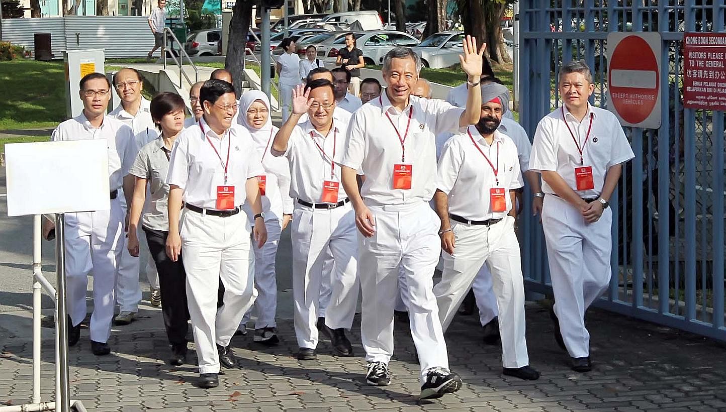 PM Lee Hsien Loong (front) arriving at the Chong Boon Secondary School polling station with his fellow PAP candidates for the Ang Mo Kio GRC during the General Election in 2011. The party may be firming up its slate, but electoral boundaries for the 