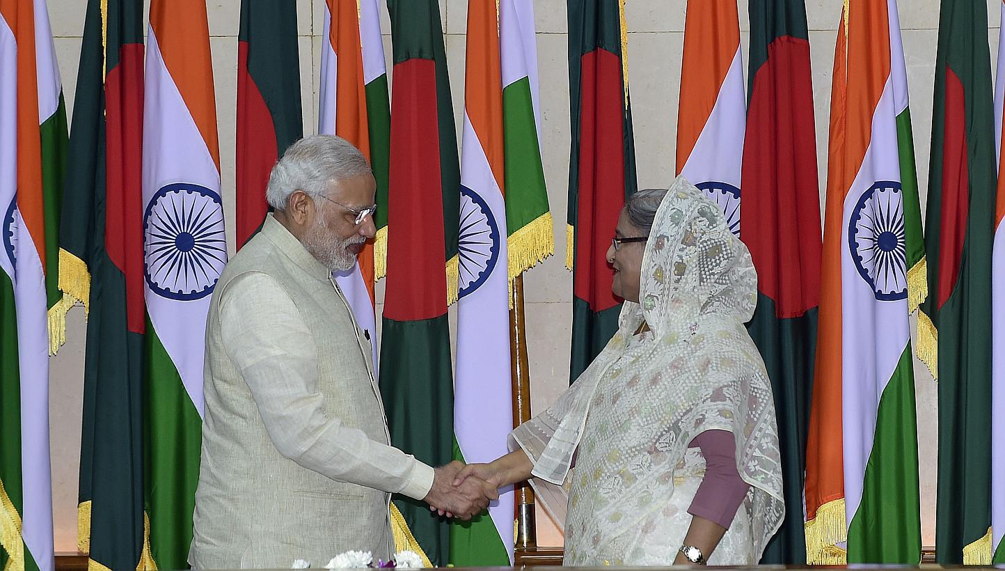 Indian Prime Minister Narendra Modi (left) shakes hand with Bangladeshi Prime Minister Sheikh Hasina Wajid after their meeting at the Prime Minister's Office in Dhaka on June 6, 2015. The two neighbours signed a historic pact on Friday&nbsp;to simpli