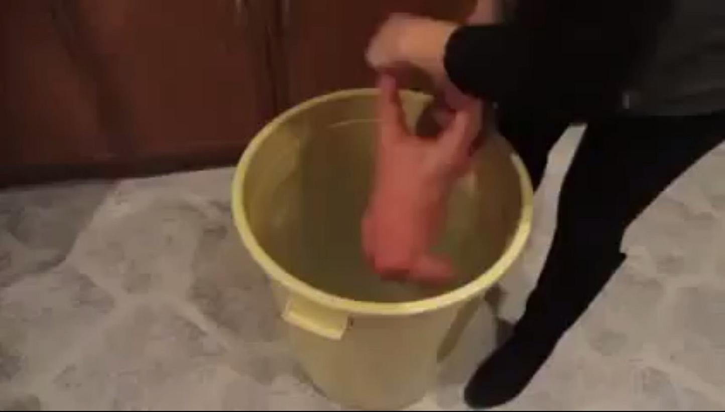 The video - running to nearly two minutes in length - shows the baby being twisted by her arms and held upside down by her legs as she is picked up and partly submerged in the water dozens of times. -- PHOTO: SCREENGRAB FROM FACEBOOK