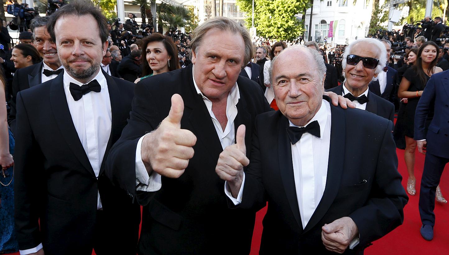 Actor Gerard Depardieu (centre), Fifa President Sepp Blatter (right) and director Frederic Auburtin posing on the red carpet for the screening of the film United Passions at the 67th Cannes Film Festival in Cannes, on May 18, 2014. -- PHOTO: REUTERS