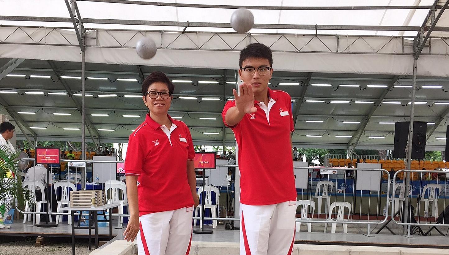Men's petanque captain Cheng Zhi Ming (right) failed to qualify for the shooting semi-finals. Teammate Heo Boon Huay (left) also suffered a similar fate. -- ST PHOTO: JEREMY LIM 