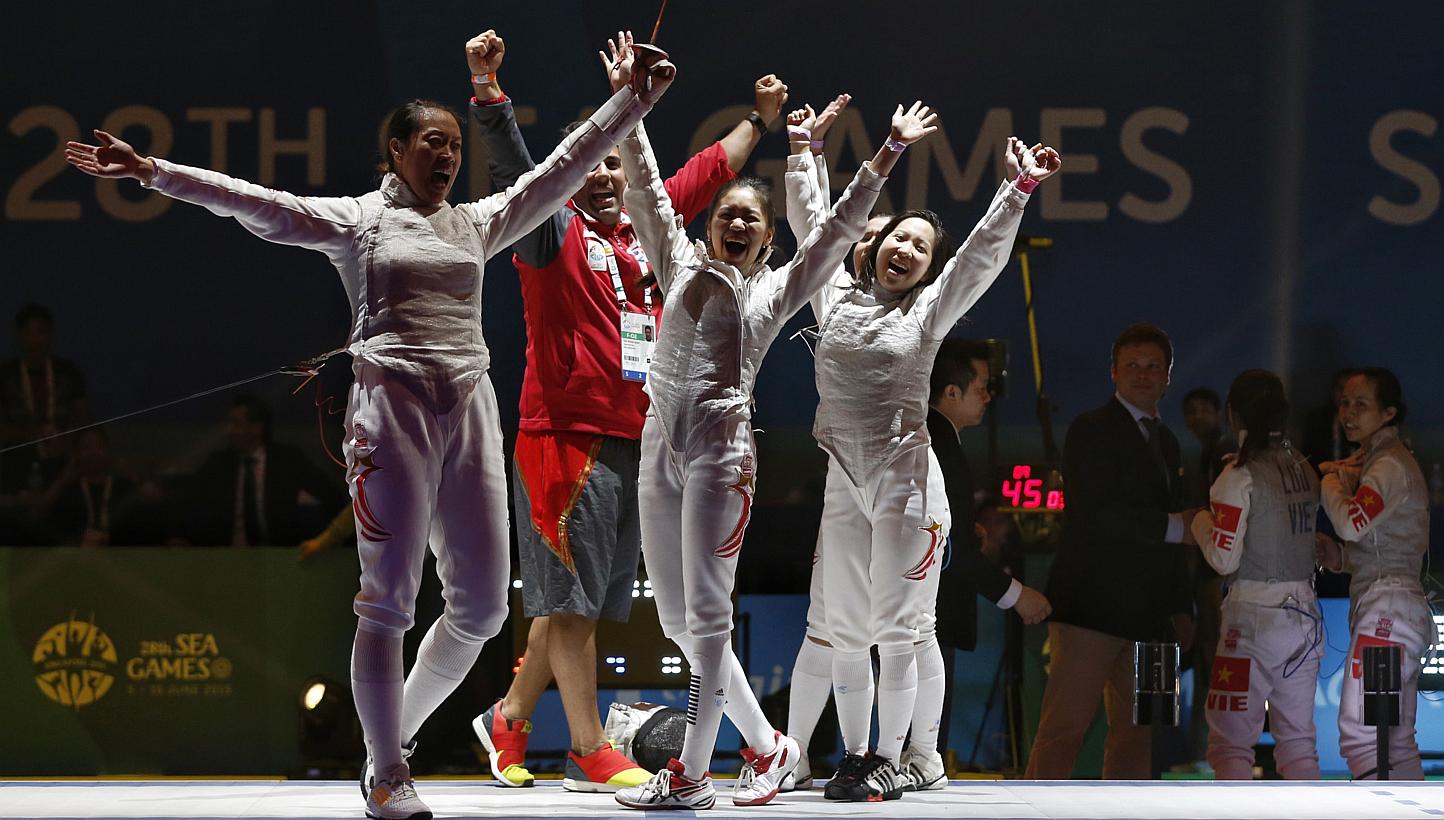 Singapore's women's foil team of (from left) Wang Wenying, Nicole Wong, Cheryl Wong and Liane Wong (hidden) celebrating after they beat Vietnam 45-26 in the SEA Games final on June 6, 2015. -- ST PHOTO: KEVIN LIM &nbsp;
