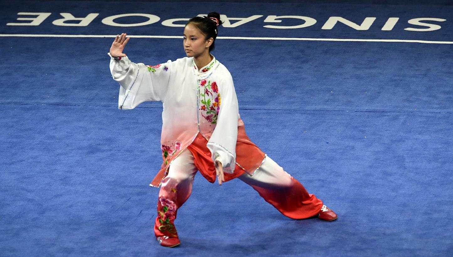 Singapore's wushu exponent Vera Tan competing in the women's taijiquan compulsory event, in which she won the gold, at the Singapore Expo Hall on June 6, 2015. -- PHOTO: AFP&nbsp;