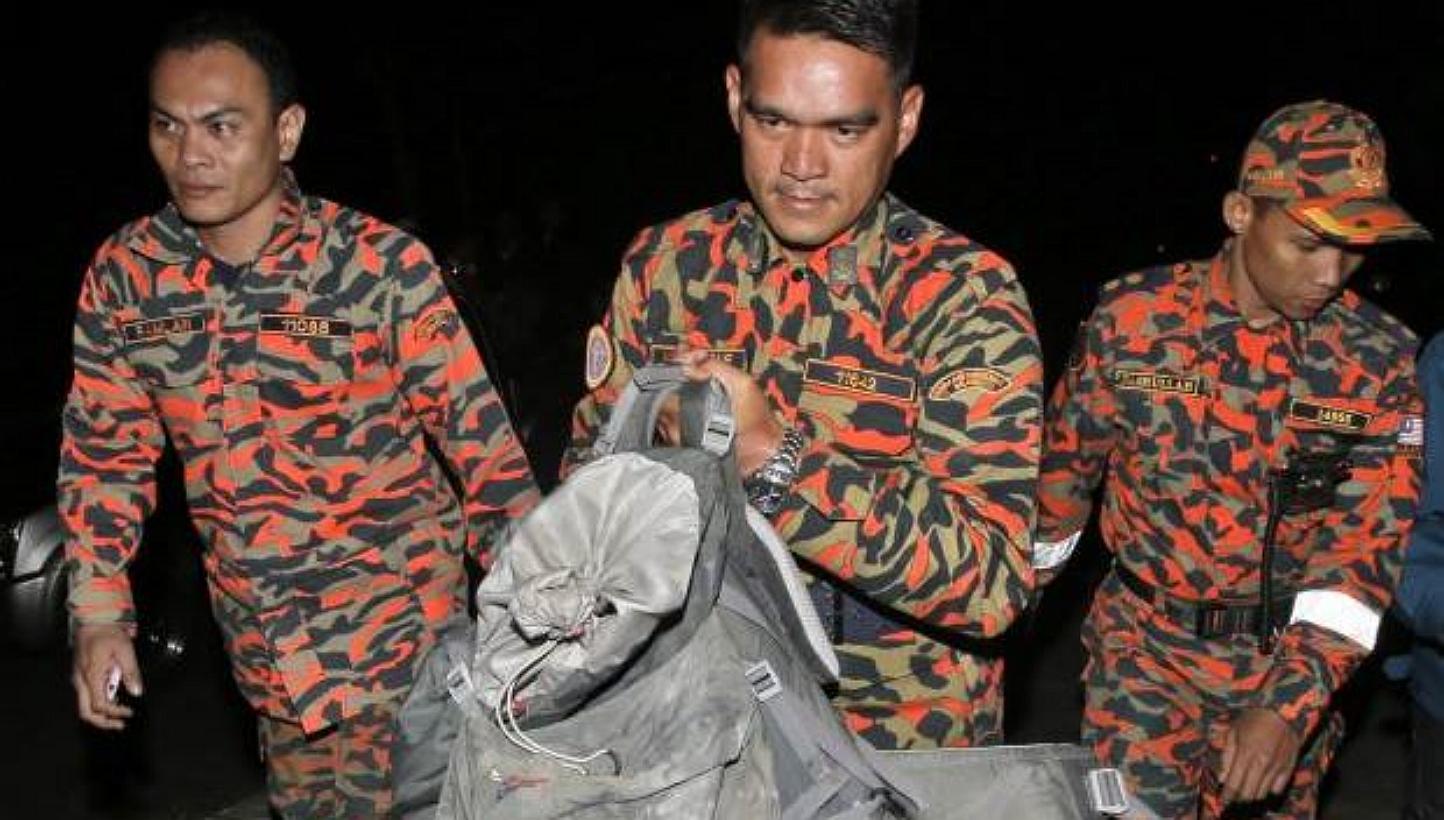 Efforts to bring down bodies of climbers from Mount Kinabalu have been hampered as some are crushed and pinned under tonnes of rocks and boulders after Friday's earthquake. -- PHOTO: THE STAR/ASIA NEWS NETWORK 