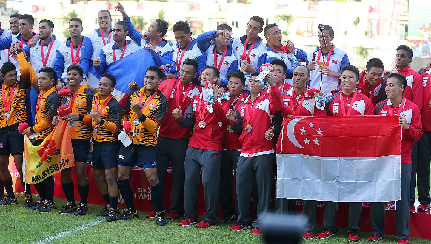 Singapore's SEA Games men's rugby 7s team (above) had to settle for a bronze medal, while the women took silver. -- PHOTO: THE NEW PAPER