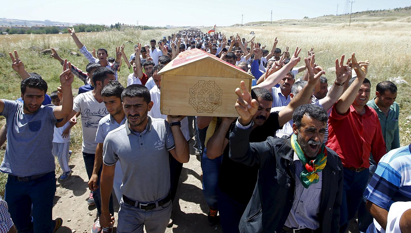 Kurdish mourners carry the coffin of Ramazan Yildiz, one of the victims in Friday's explosion, during his funeral at a cemetery in Diyarbakir, Turkey, June 6, 2015.&nbsp;Turkey on Saturday prepared for its tightest elections in over a decade, with te