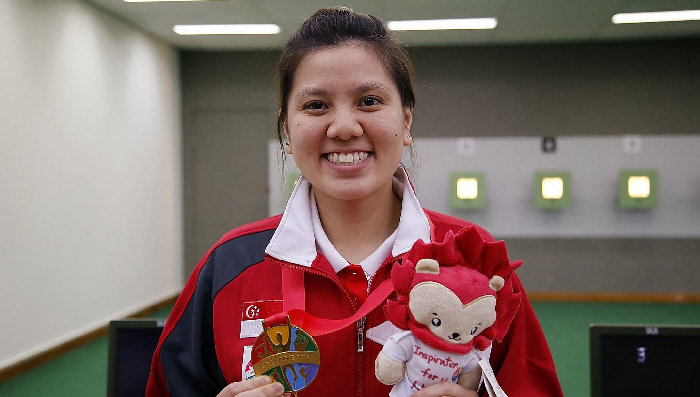 Singapore shooter Teo Shun Xie holding up her SEA Games gold medal in the women's individual 10m air pistol event on June 7, 2015. -- PHOTO: SINGAPORE SEA GAMES ORGANISING COMMITTEE/ACTION IMAGES VIA REUTERS
