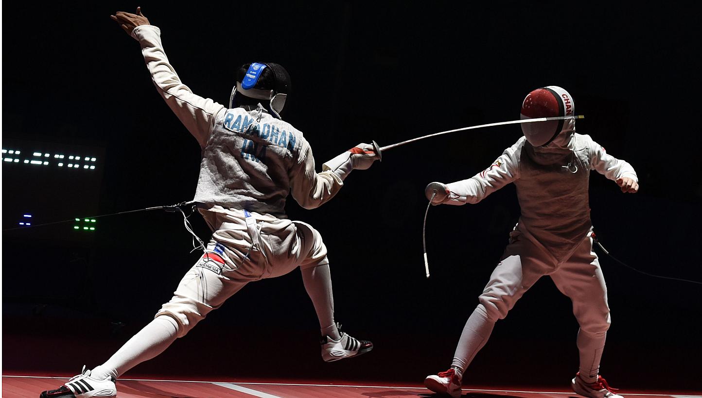 Kevin Jerrold Chan (right) of Singapore competes against Tauhid Ramadhan (left) of Indonesia during the 28th SEA Games held in Singapore on June 7, 2015. -- PHOTO: AFP