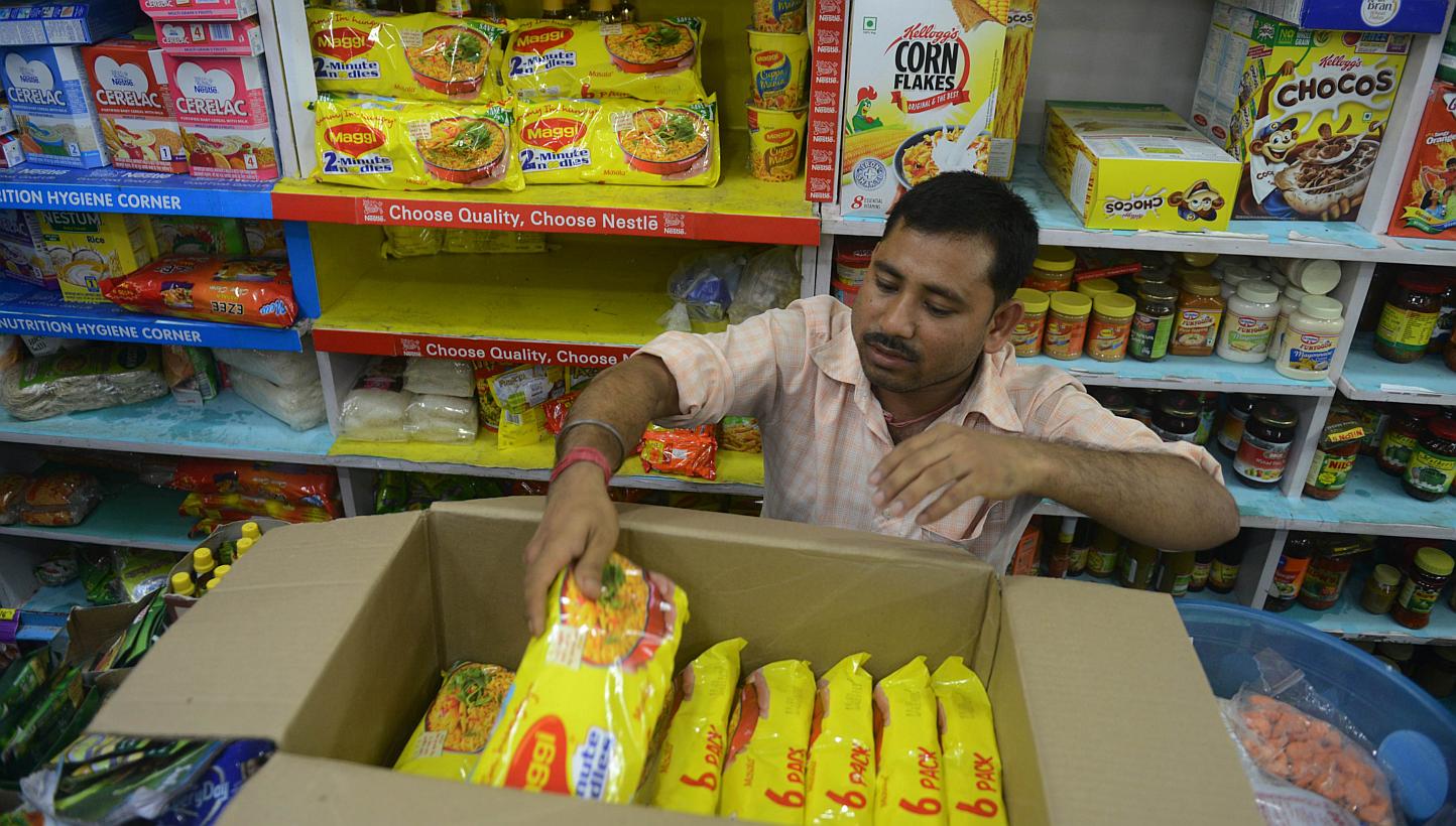 An Indian shopkeeper removes packets of Nestle Maggi instant noodles from the shelves in his shop in Siliguri on June 5, 2015. India's food safety regulator on June 5 banned the sale and production of Nestle's Maggi instant noodles over a health scar