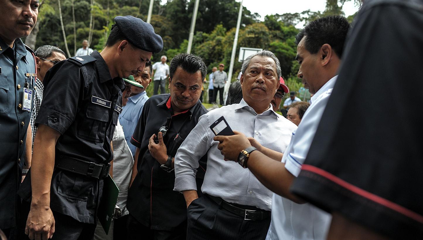 Malaysia's Deputy Prime Minister Muhyiddin Yassin (second right) waits after being evacuated following an aftershock while at the Liwagu Restaurant for a press conference, near Mount Kinabalu in Kundasang, a town in the district of Ranau on June 7, 2