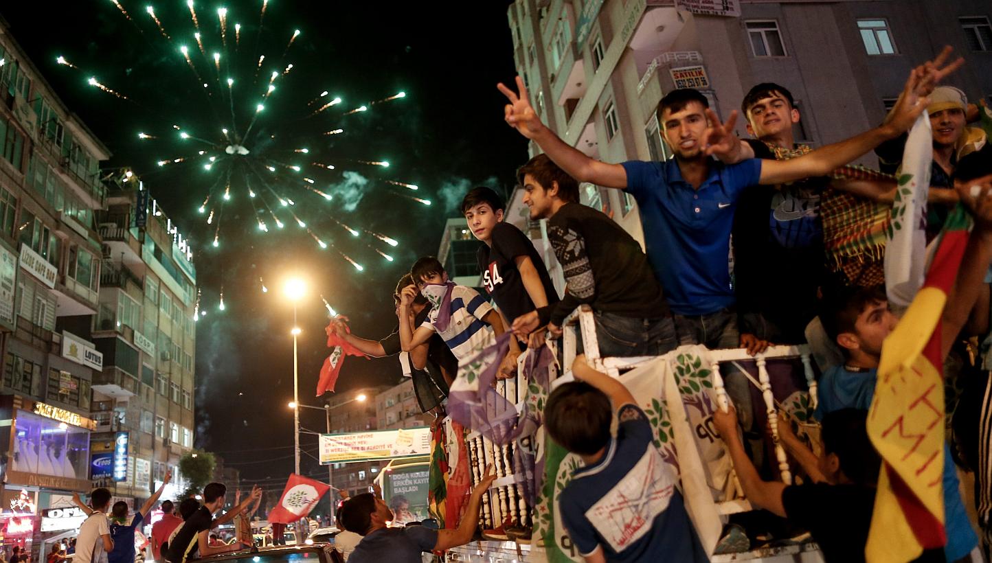 Supporters of the Peoples' Democratic Party (HDP) drive in a car convoys and launch firework in the streets as they celebrate the results of the Turkish parliamentary elections, in Diyarbakir, Turkey, on June 8, 2015. -- PHOTO: EPA