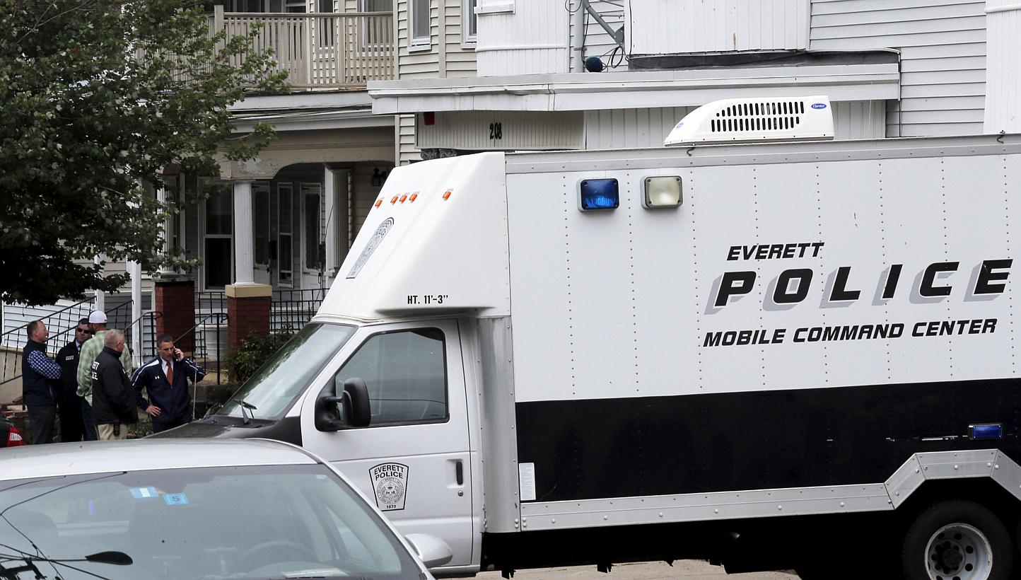 Law enforcement officials are gathered on a residential street in Everett, Massachusetts on June 2, 2015 in connection to a man shot dead by law enforcement in Boston after coming at them with a large knife when they tried to question him as part of