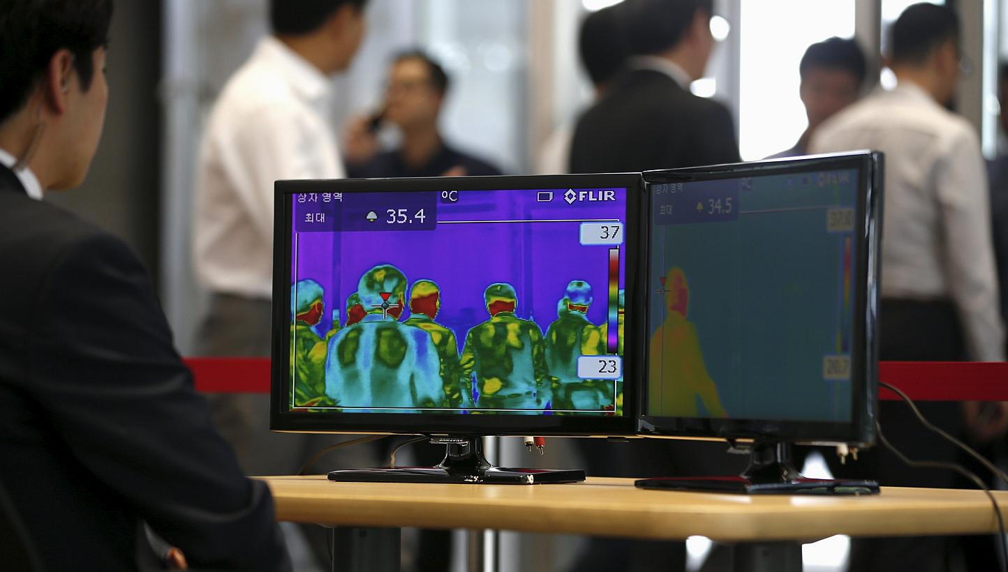 Employees walking past a thermal imaging camera at an office buliding in central Seoul, South Korea, on June 9, 2015, as fears over an outbreak of Middle East respiratory syndrome (Mers)&nbsp;grips the country.&nbsp;The Philippines has had close brus