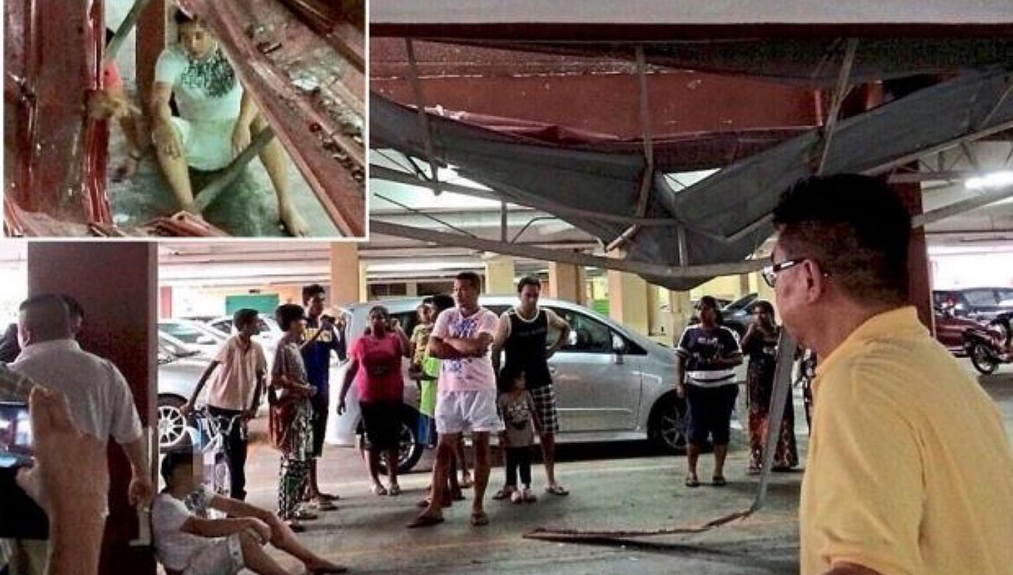 Residents checking on the dazed man (inset) after he fell from the eighth floor of a condominium. -- PHOTO: THE STAR/ ASIA NEWS NETWORK&nbsp;