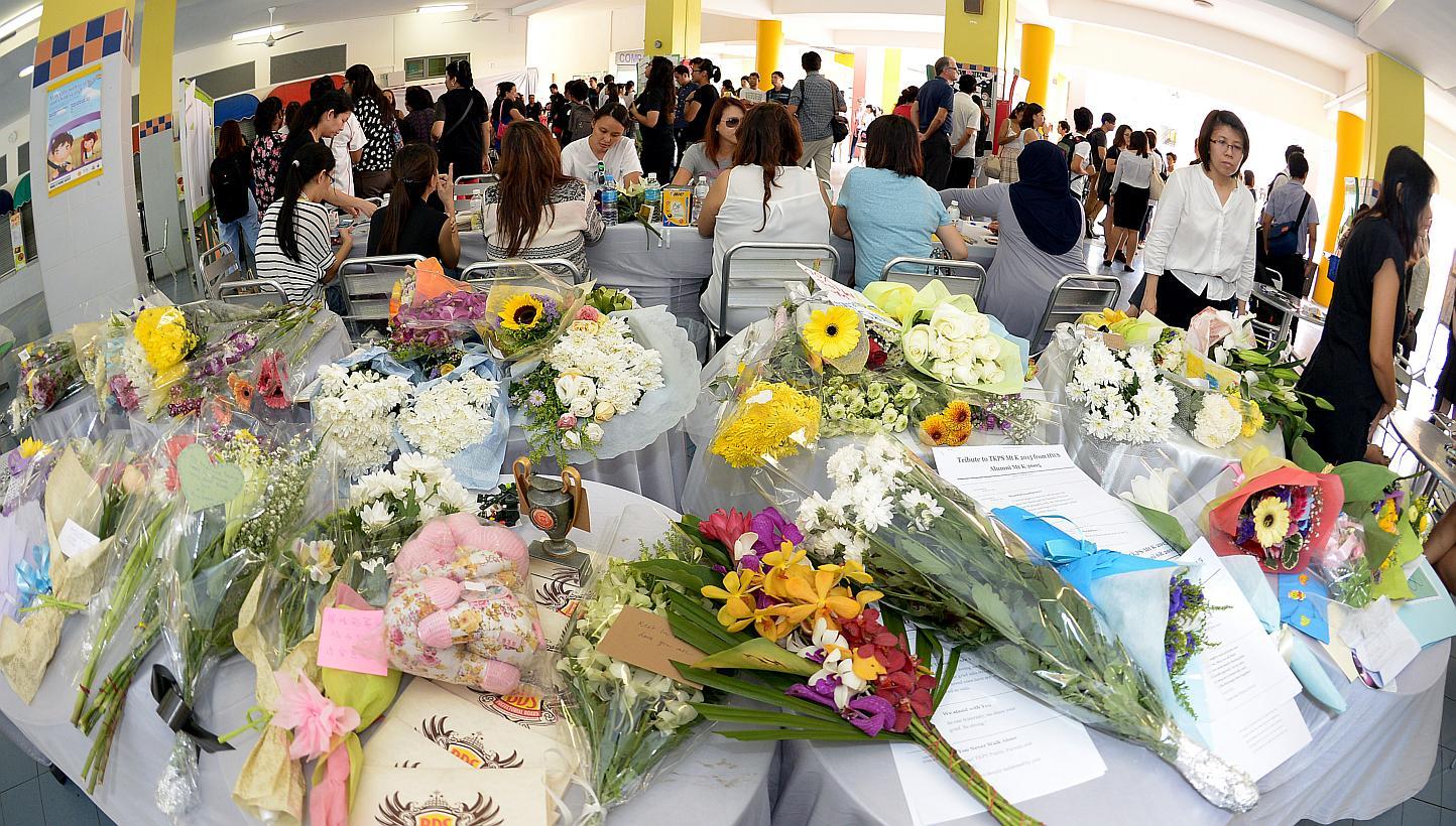 Bouquets of flowers that were left by hundreds of parents, pupils, alumni and staff at a condolence site in the school porch of Tanjong Katong Primary School on June 8, 2015. -- ST PHOTO: DESMOND WEE&nbsp;