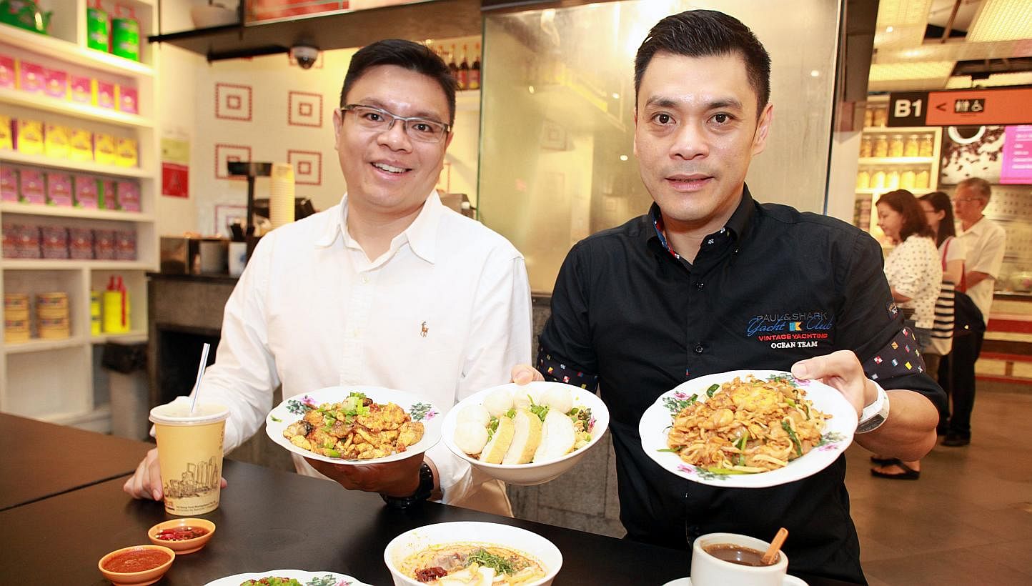 Fei Siong’s group managing director Tan Kim Siong (right) and executive director Tan Kim Leng (left) want to preserve Singapore’s food culture by getting old hawkers to share their recipes. -- PHOTO: MIKE LEE FOR THE STRAITS TIMES
