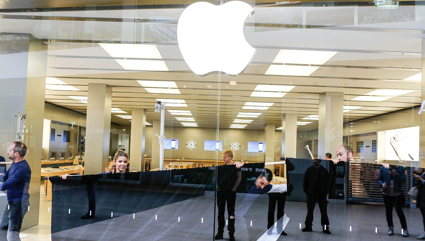 Employees an Apple Store in Lyon, France, on April 10, 2015. At least two Apple retail store workers complained directly to Chief Executive Tim Cook that the company's policy of checking employees' bags as a security precaution was embarrassing and d