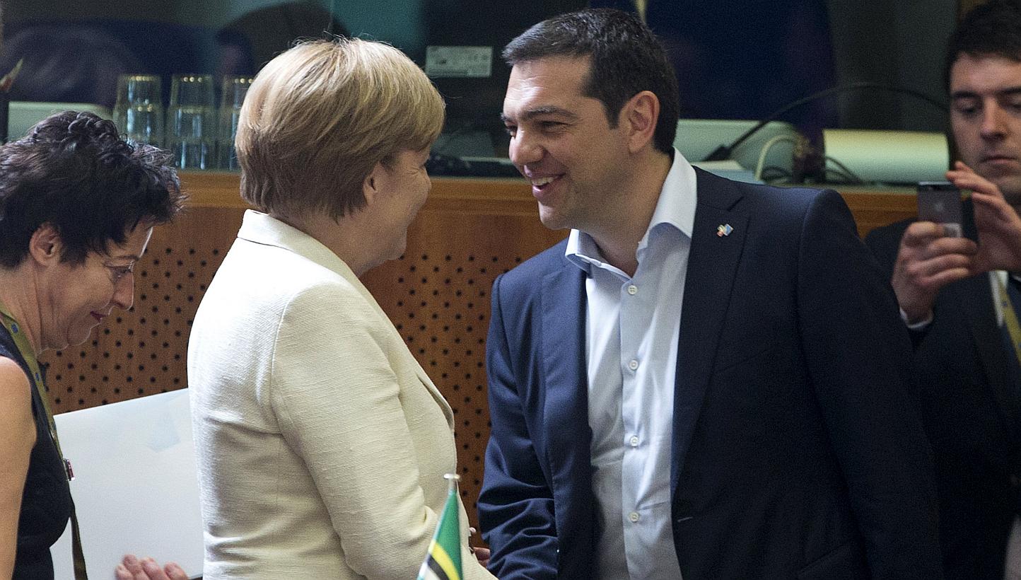 German Chancellor Angela Merkel (left) shakes hands with Greek Prime Minister Alexis Tsipras (right) at the start of an EU-CELAC Latin America summit in Brussels, Belgium on June 10, 2015. -- PHOTO: REUTERS