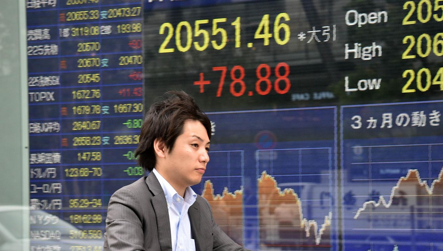 Asian stocks gained early on Thursday after seeing Wall Street shares halt their selloff, while the New Zealand dollar tumbled to a five-year low after the Reserve Bank there cut its overnight cash rate. -- PHOTO: AFP