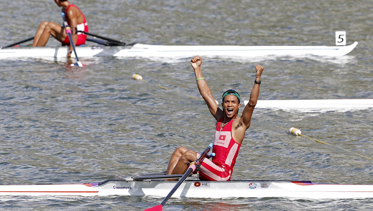 Vietnam's Nguyen Van Linh (bottom) celebrating his win in the lightweight single sculls event on June 11, 2015. -- PHOTO: REUTERS