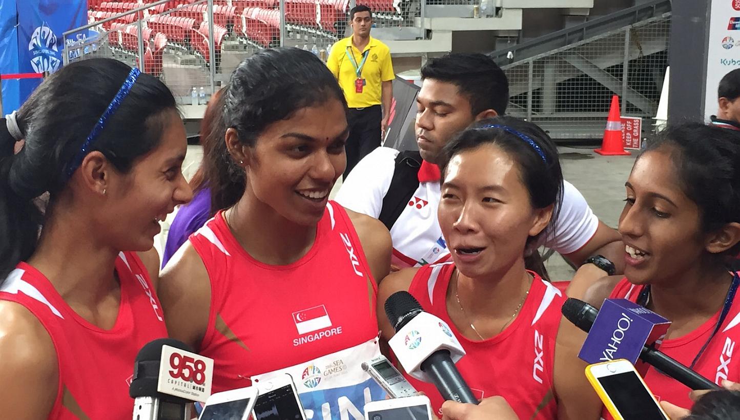 Singapore's 4x400m relay quartet of (from left) Dipna Lim-Prasad, T. Piriyah, Goh Chui Ling and Shanti Pereira smashed a 41-year-old national record but could only finish fourth. -- ST PHOTO: MAY CHEN