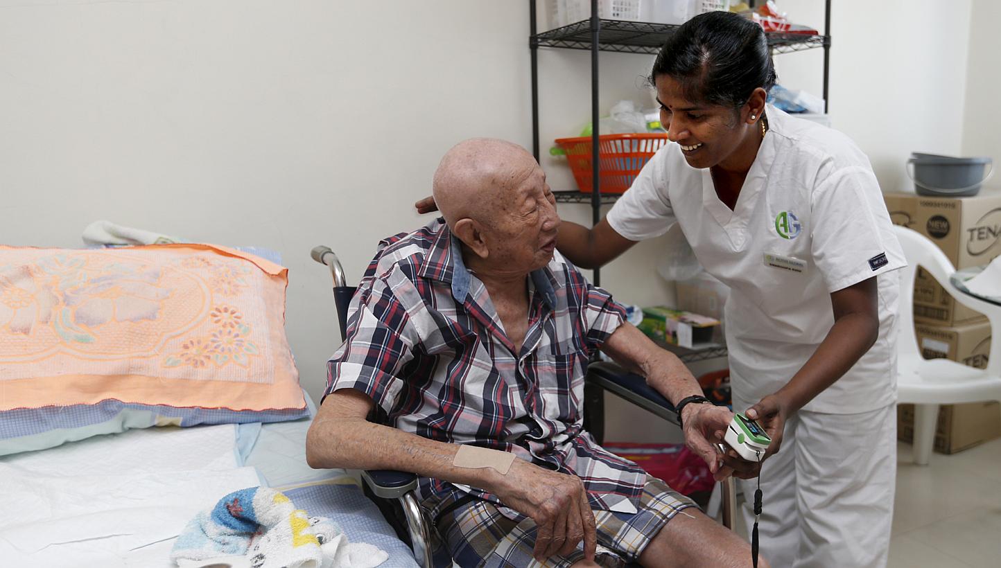 Ms Swaroopa Rani, a nurse from India, takes care of Mr Goh Chong Huat at his home near Bedok. He used to be in and out of hospital every month, but has not had to be hospitalised since Ms Rani started caring for him.