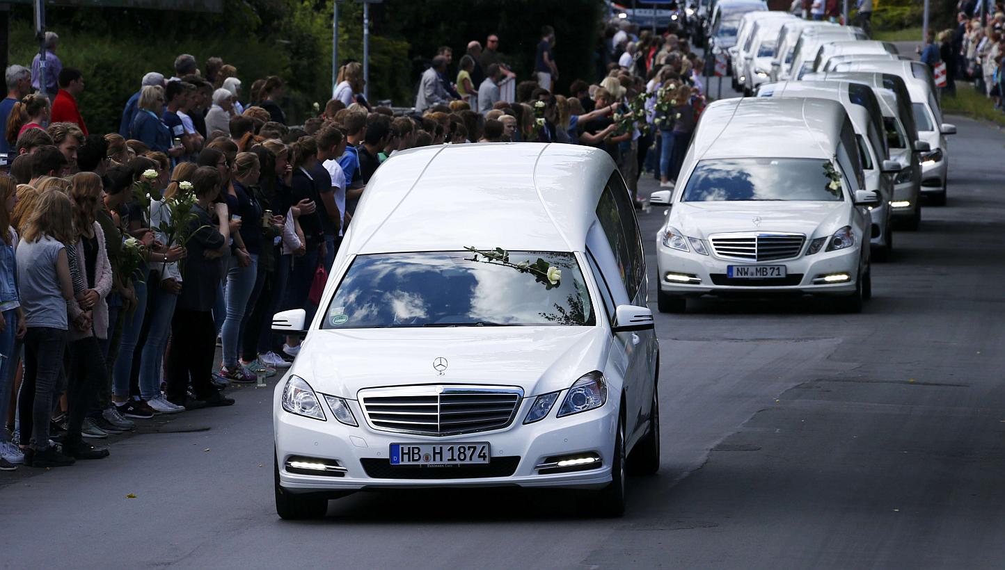 Hearses carrying the remains of victims of the Germanwings plane disaster drive past the Joseph-Koenig-Gymnasium high school, where 16 of the victims went to school, in Haltern am See, Germany, on June 10, 2015. -- PHOTO: REUTERS