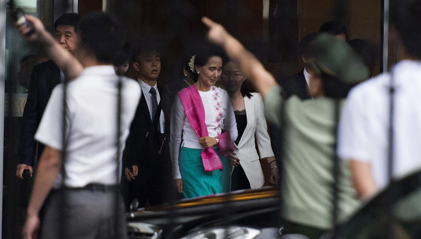 Myanmar pro-democracy leader Aung San Suu Kyi leaves the airport following her arrival in Beijing on June 10, 2015. -- PHOTO: AFP&nbsp;