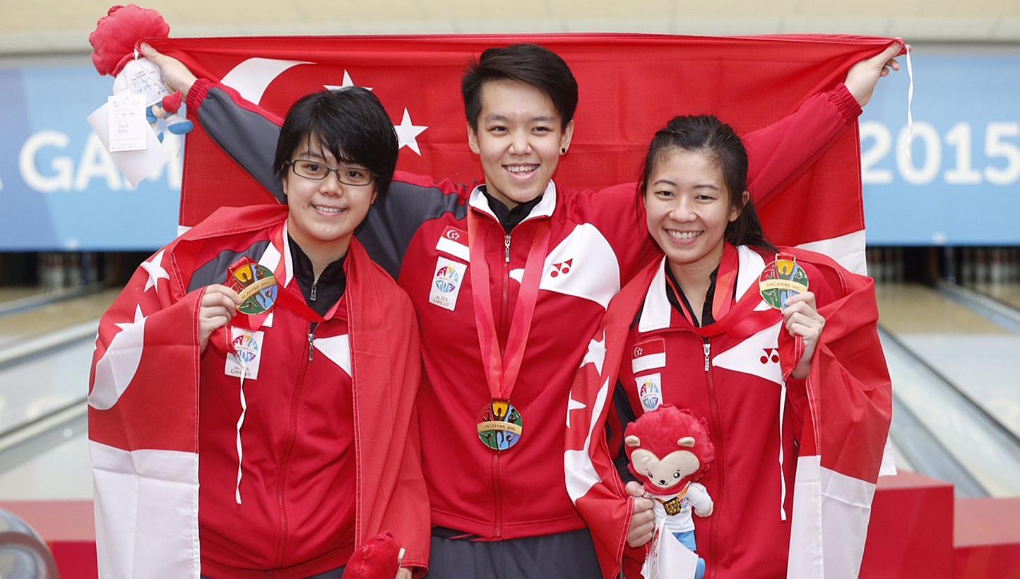 Singapore's (from left) Cherie Tan, Shayna Ng and Bernice Lim with gold medals from the women's trios event during the 28th SEA Games at Orchid Country Club on June 11, 2015. -- ST PHOTO: KEVIN LIM 