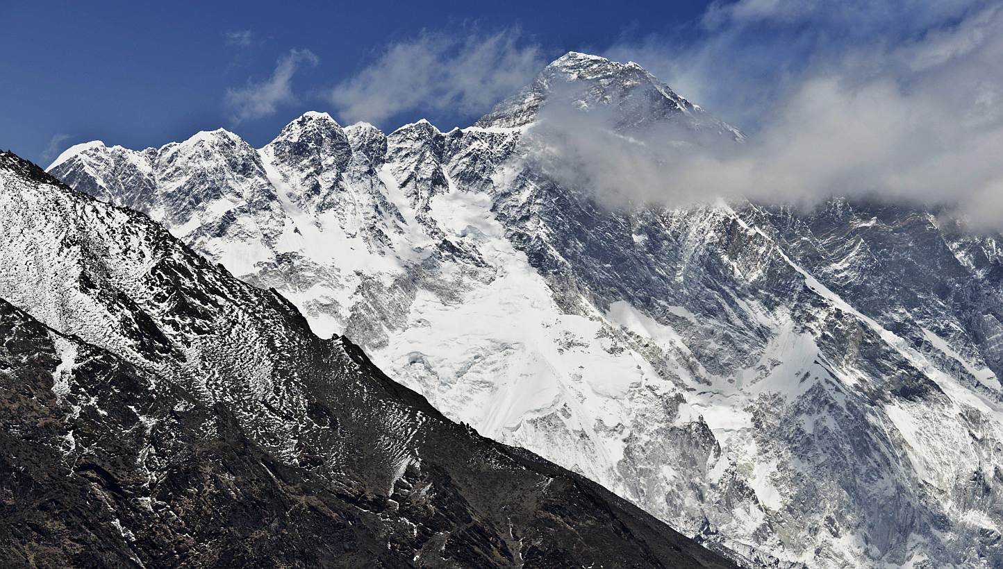 A view of Mount Everest (background) towering over the Nupse-Lohtse massif (foreground) from the village of Tembuche in the Khumbu region of north-eastern Nepal on April 20, 2015. -- PHOTO: AFP