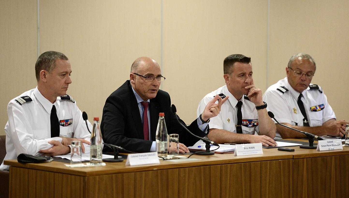 French prosecutor of Marseille Brice Robin (centre) speaking as French Colonel Francois Daoust (left), head of the criminal research Institute of the French Gendarmerie, and Colonel Simon-Pierre Delannoy (second, right), head of the research section