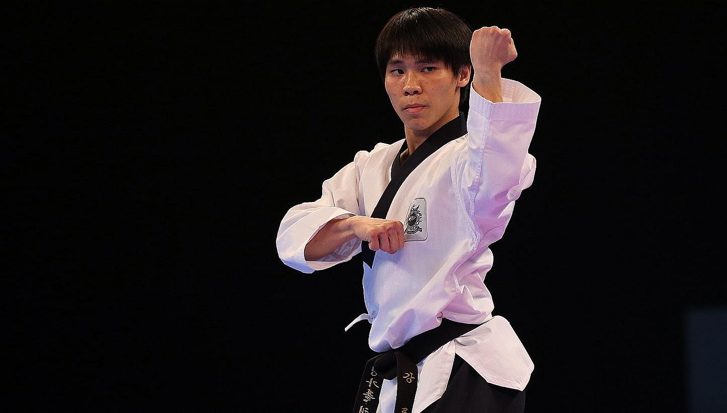Singapore's Kang Rui Jie won the gold medal for the 28th SEA Games men's individual poomsae finals held at the Singapore Expo Hall 2 on June 12, 2015. -- ST PHOTO: NEO XIAOBIN