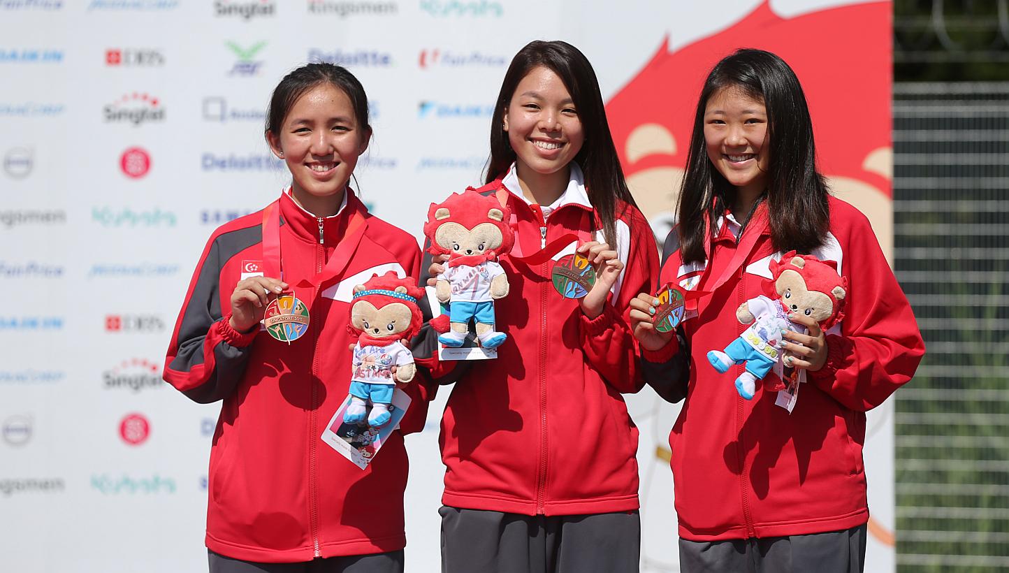 (From left) Shooters Jasmine Ser, Cheng Jian Huan and Li Yafei after winning a bronze in the women's 50m rifle prone team event on June 10, 2015. The trio also won bronze in the women's 50m rifle three-positions event on June 12. -- ST PHOTO: ONG WEE