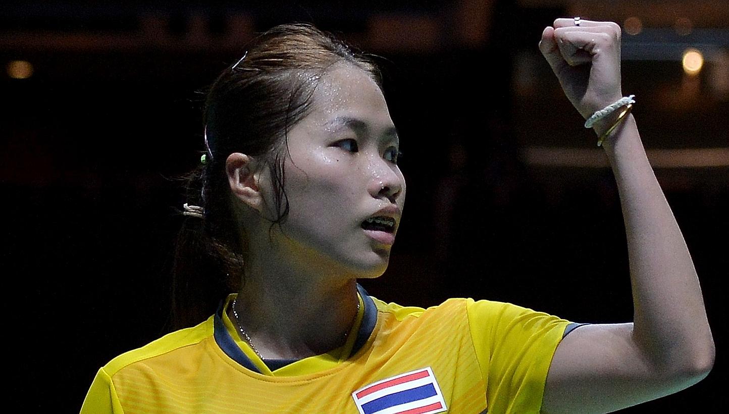 Ratchanok Intanon of Thailand reacts after winning a point against Lim Yin Fun of Malaysia in their women's team badminton final match during the 28th SEA Games in Singapore on June 12, 2015. -- PHOTO: AFP 