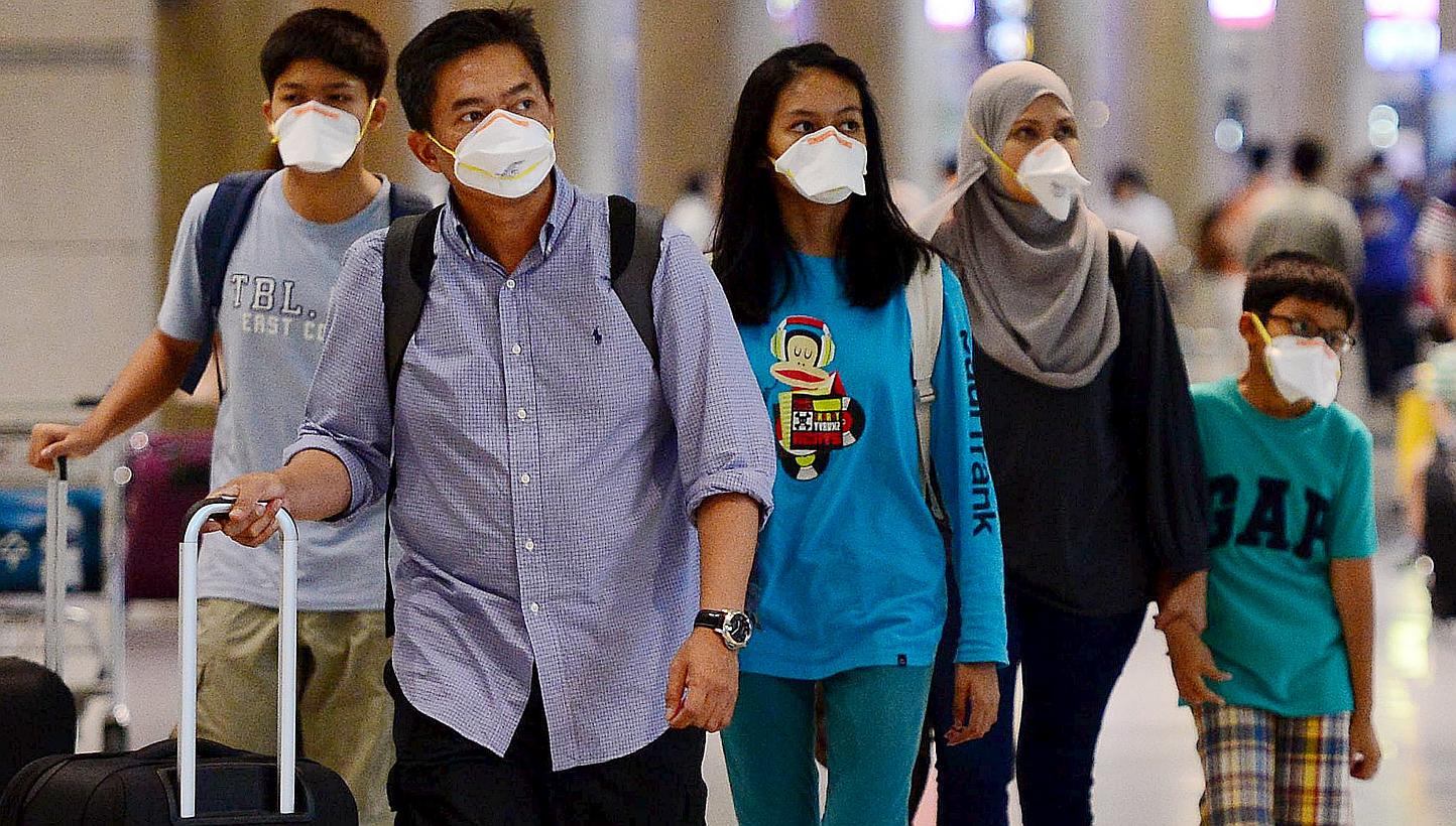 Tourists wearing masks to prevent themselves from contracting Middle East Respiratory Syndrome (Mers) arrive at the Incheon International Airport in South Korea on June 7, 2015. -- PHOTO: REUTERS