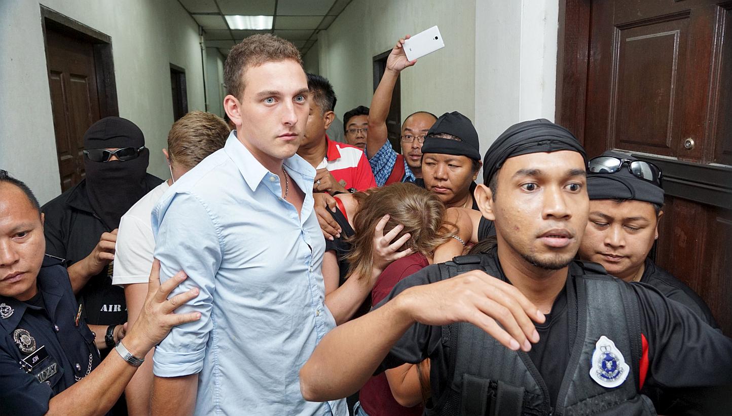 Dutch national Dylan Snel (centre) leaving a court hearing along with Canadian siblings Lindsey (third from left, obscured) and Danielle Petersen (in black, with face obscured) and British national Eleanor Hawkins (third from right, obscured) in Kota