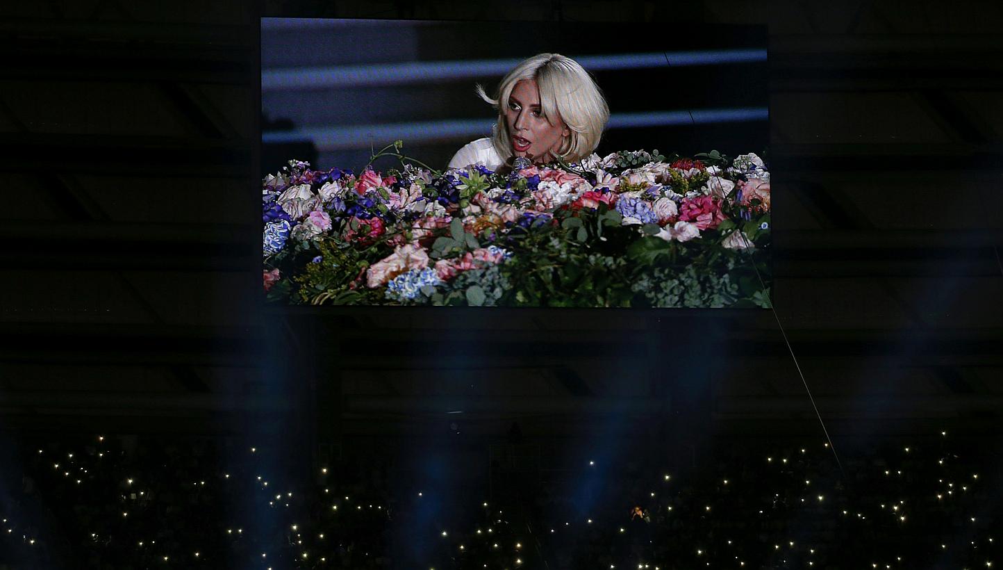 Pop star Lady Gaga is seen on a videowall while fans light their phones during the opening ceremony of the 1st European Games in Baku, Azerbaijan, on June 12, 2015. -- PHOTO: REUTERS