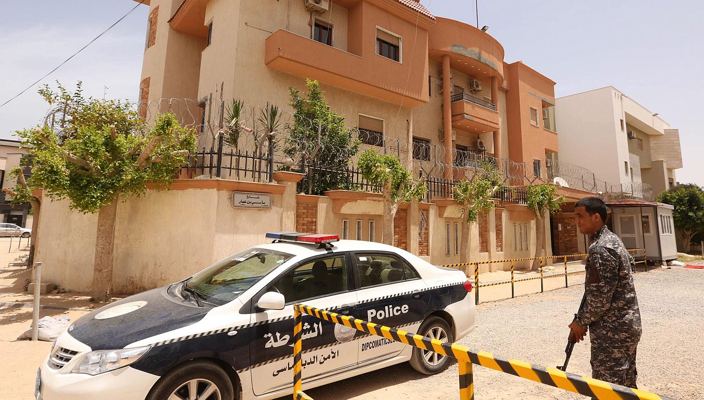 A policeman stands guard outside the Tunisian consulate in Tripoli on June 13, 2015. Libyan militiamen kidnapped 10 staffers from Tunisia's consulate in Tripoli on June 12 after storming the mission. -- PHOTO: AFP 