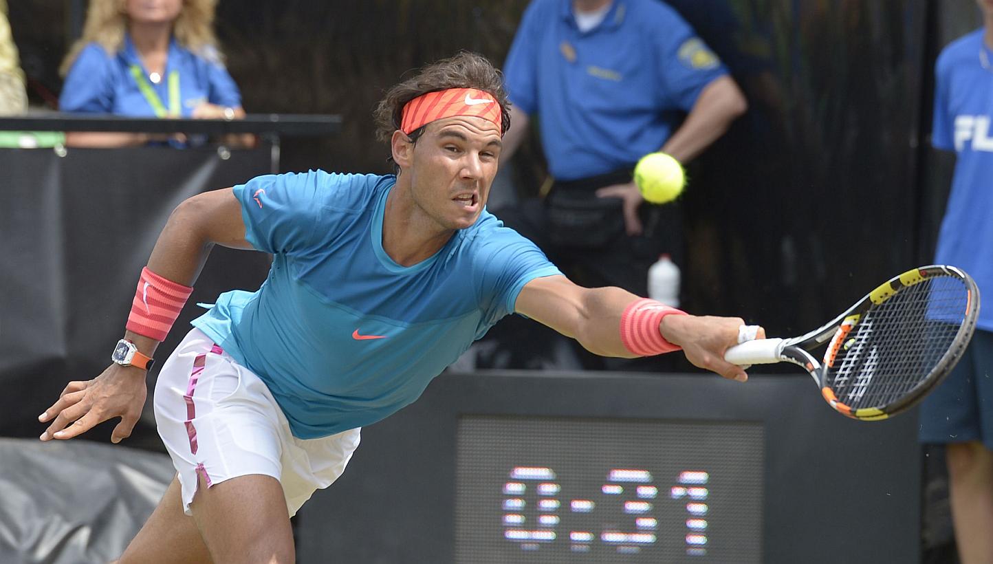 Spain's Rafael Nadal returns the ball to Australia's Bernard Tomic during their quarterfinal match at the ATP Mercedes Cup tennis tournament in Stuttgart, southern Germany, on June 12, 2015. -- PHOTO: AFP
