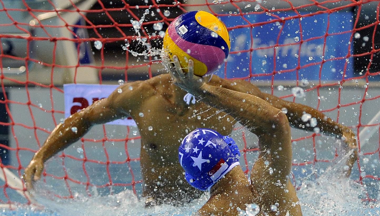 Singapore's Chiam Kunyang (No. 7) attempting to score against his Filipino opponent in their men's water polo match at the OCBC Aquatic Centre on June 14, 2015. -- PHOTO: SINGAPORE SEA GAMES ORGANISING COMMITTEE/ACTION IMAGES VIA REUTERS