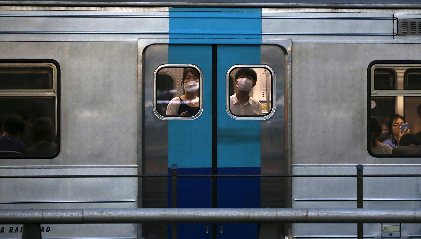 Passengers wearing masks to prevent contracting Middle East Respiratory Syndrome (Mers) look out from a subway train in Seoul, South Korea, on June 12, 2015. -- PHOTO: REUTERS 