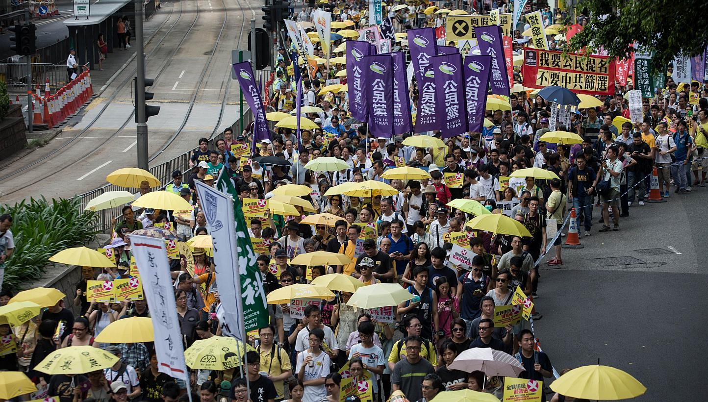 People marching during a pro-democracy rally in Hong Kong on June 14, 2015. The turnout is smaller than expected. -- PHOTO: AFP