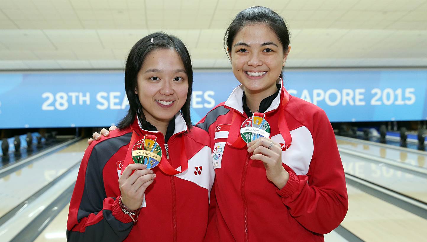 (Left-right) Singapore's Jazreel Tan and Daphne Tan finishing first and second respectively in the bowling women's masters final of the 28th SEA Games on Sunday, on June 14, 2015, at the Orchid Country Club. -- ST PHOTO: SEAH KWANG PENG