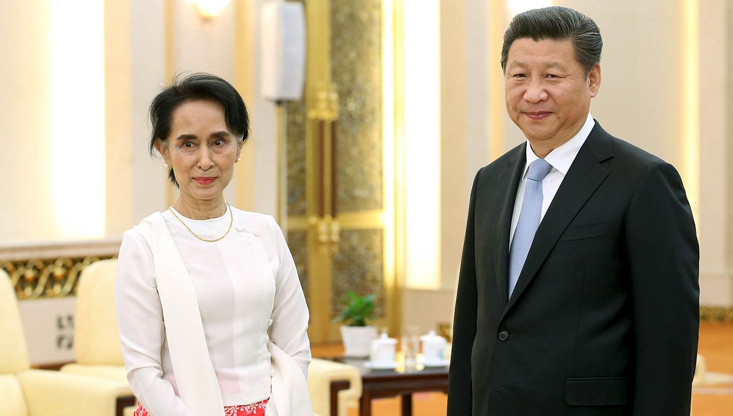 China's President Xi Jinping and Myanmar pro-democracy leader Aung San Suu Kyi pose for pictures during their meeting at the Great Hall of the People in Beijing, China, on June 11, 2015. The Myanmar opposition leader wrapped up her first visit to Chi