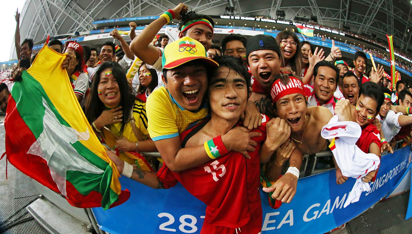 Myanmar footballer Zaw Hein Thiha (centre) celebrating with fans after his country's shock 2-1 win over Vietnam in the SEA Games men's football semi-finals at the National Stadium on June 13, 2015. -- PHOTO: SINGAPORE SEA GAMES ORGANISING COMMITTEE/A