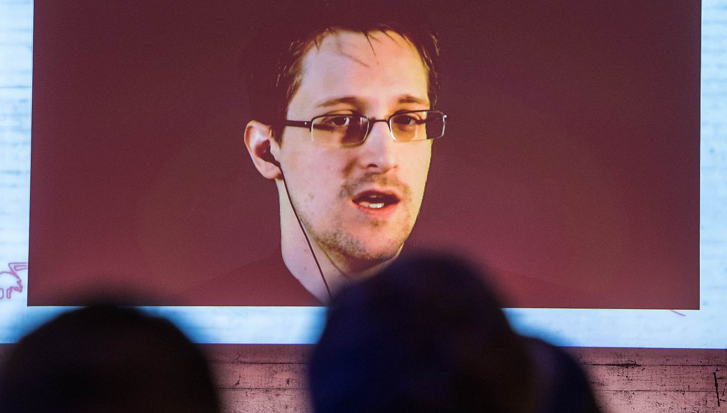 US National Security Agency (NSA) whistleblower Edward Snowden speaks via live video call during the CeBIT technology fair in Hanover, central Germany, on March 18, 2015. Britain has pulled out agents from live operations in "hostile countries" after